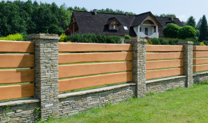 Durable fence made of wood and stone house enclosing